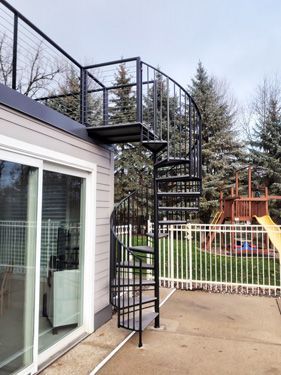 A spiral staircase leading up to the roof of a house