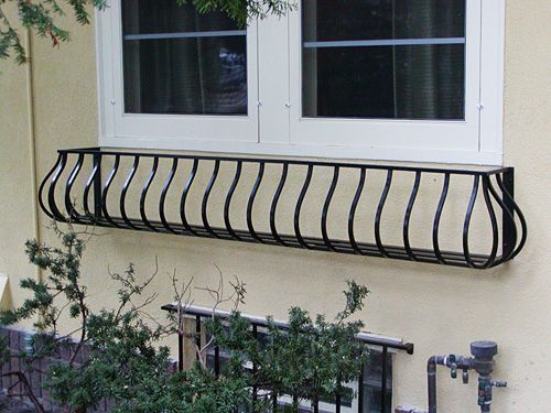 A window with a wrought iron railing on it