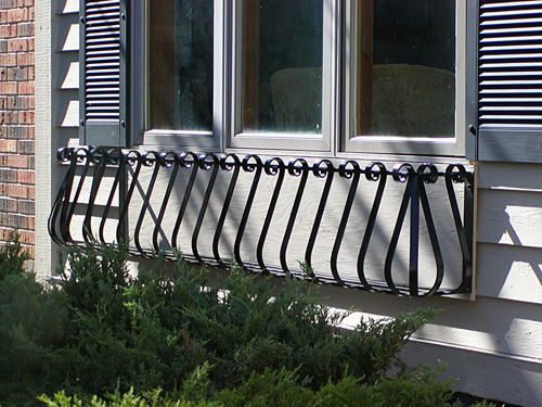 A window with a wrought iron railing on it