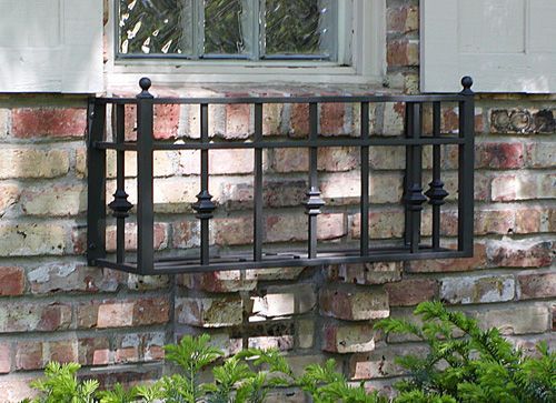 A window with a wrought iron fence around it