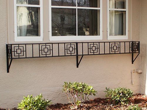 A window with a wrought iron railing on it