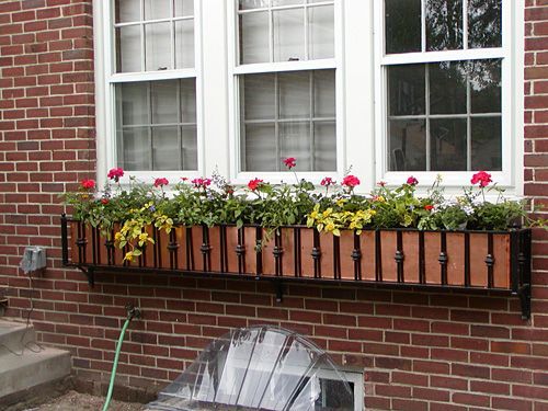A brick building with a window box filled with flowers