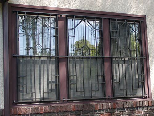 A window with a wrought iron fence around it