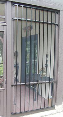 A door with a wrought iron grille on it.