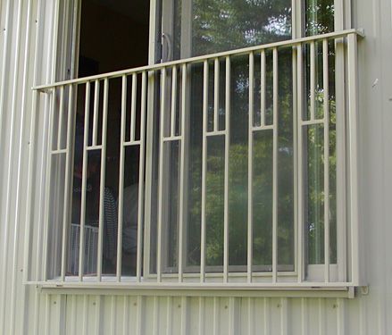 A window with a metal railing on the side of it