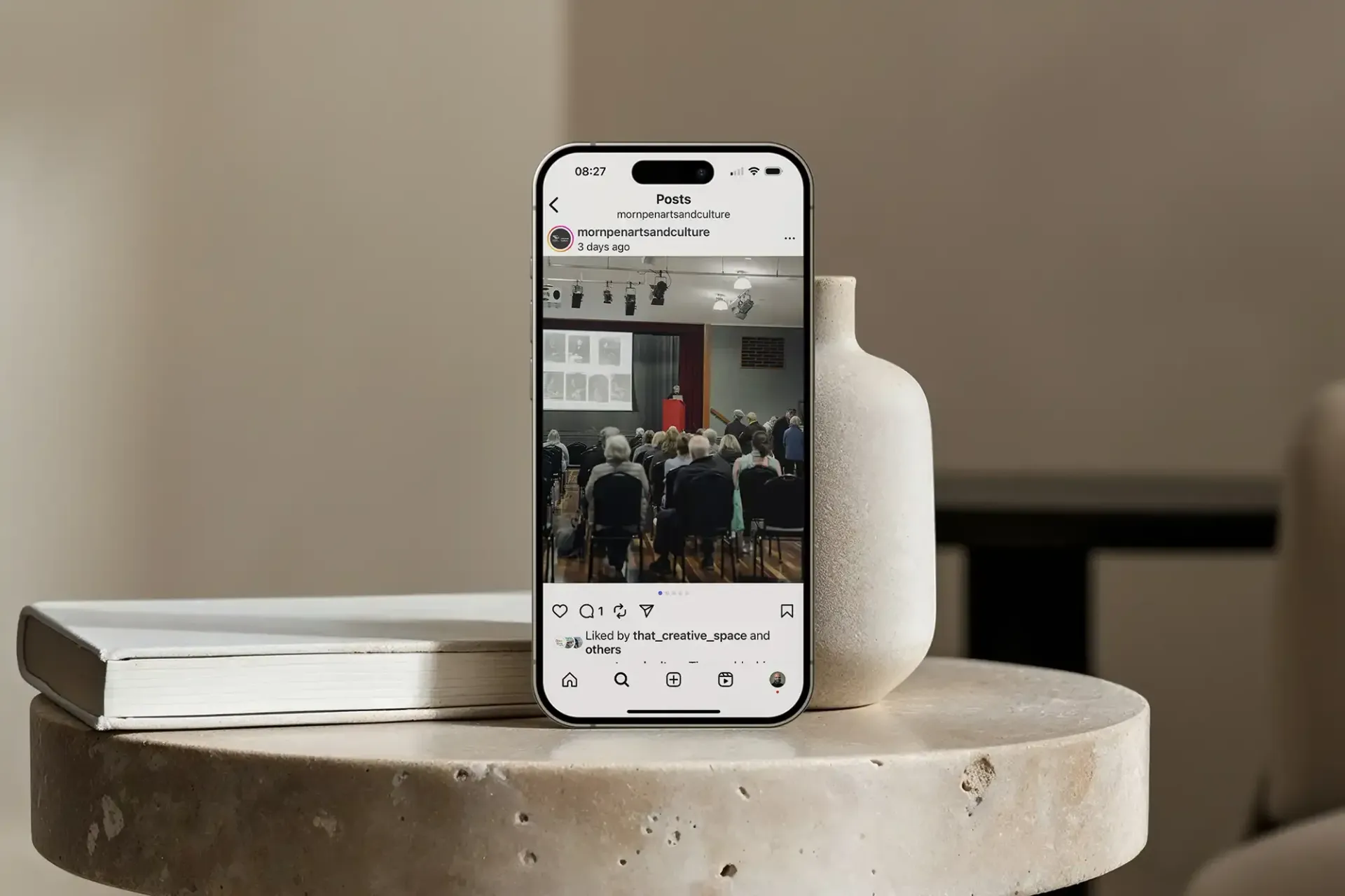 Image showing an instagram post of an event with a speaker at the front.