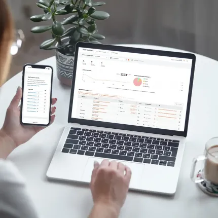 Image contains a laptop and phone showing website analytics