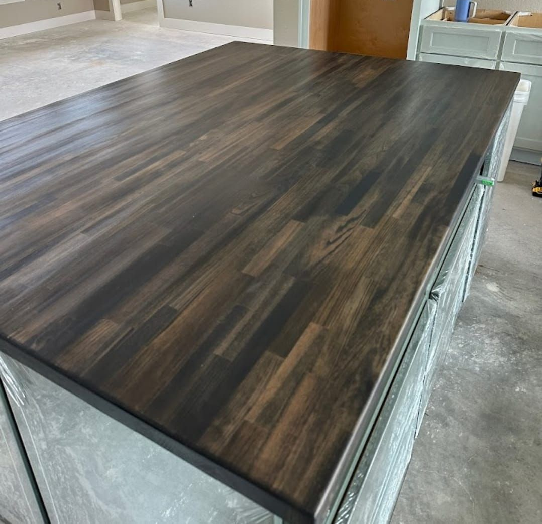 Black double sink in a wooden countertop with a chrome faucet. Black double sink in a wooden countertop with a chrome faucet.