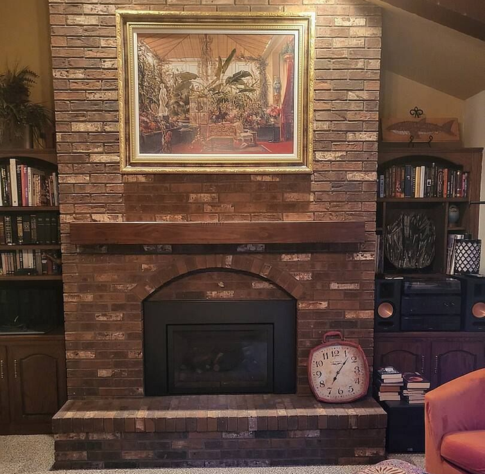 Man holding a wooden box, possibly furniture; workshop setting with wood planks and tools. Man holding a wooden box, possibly furniture; workshop setting with wood planks and tools.