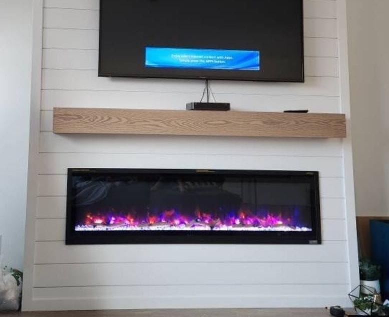 Fireplace with burning logs and a stone mantel; wood logs on each side. Fireplace with burning logs and a stone mantel; wood logs on each side.