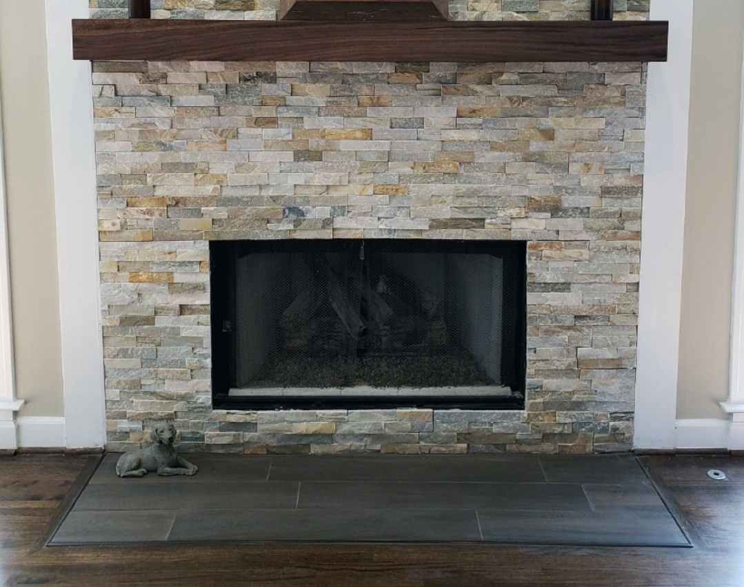 Modern living room with marble fireplace, TV, light gray sofa, wooden coffee table, and large window. Modern living room with marble fireplace, TV, light gray sofa, wooden coffee table, and large window.
