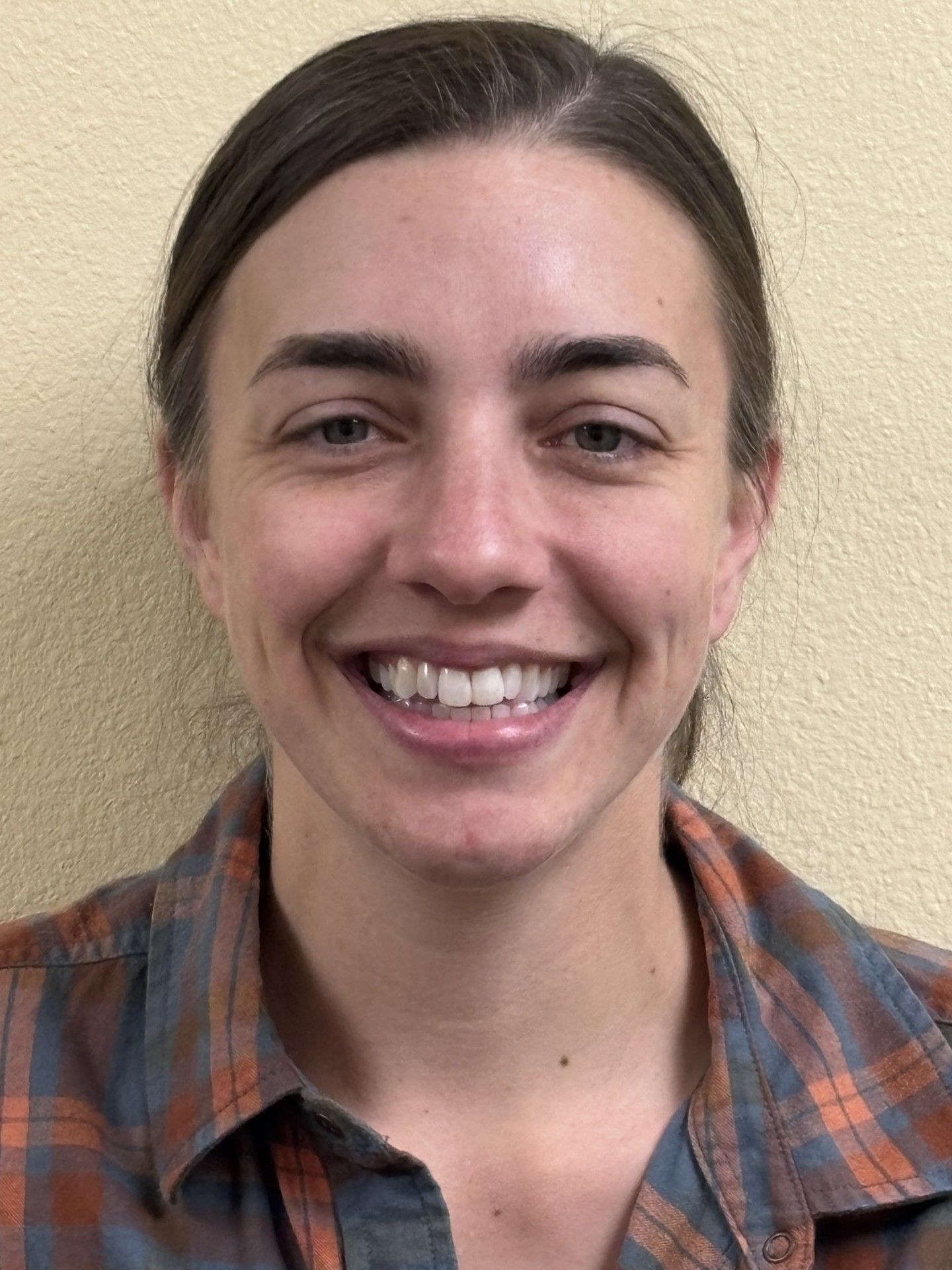 A woman smiling in a dental office