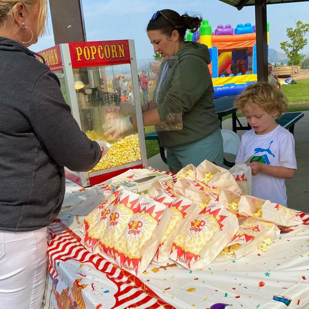 Three people enjoying the popcorn station from last year's Back to School Bash