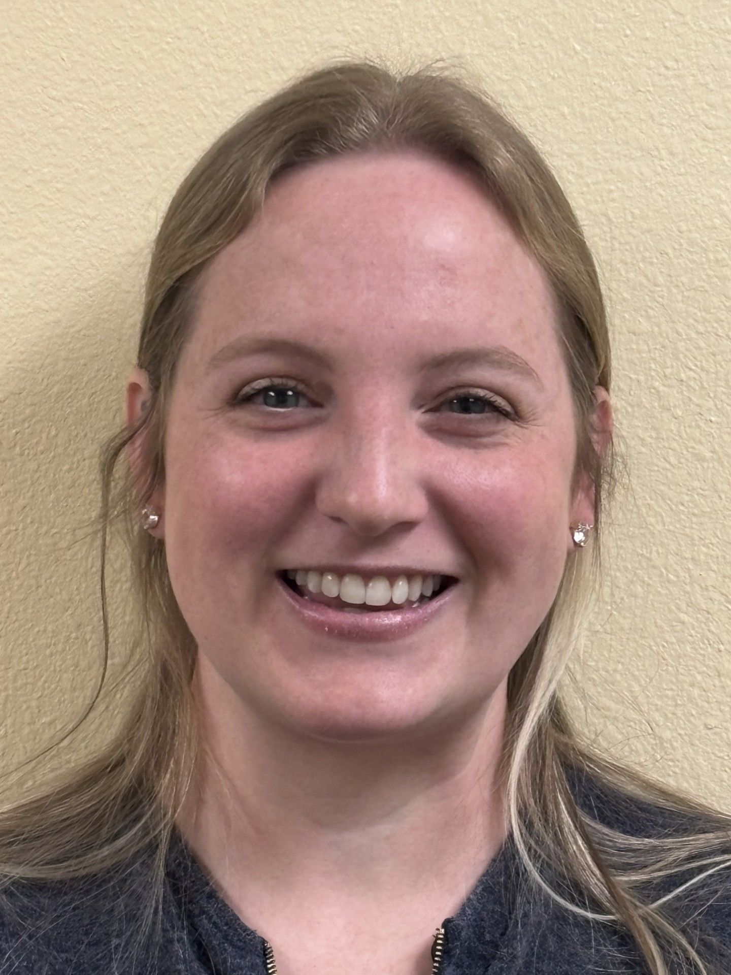 A woman smiling in a dental office