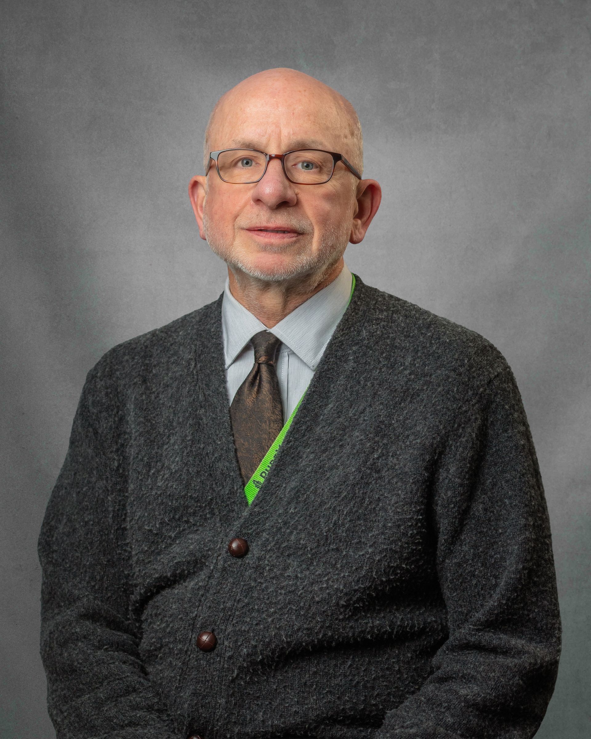 A man wearing glasses and a blue shirt that says pureview 