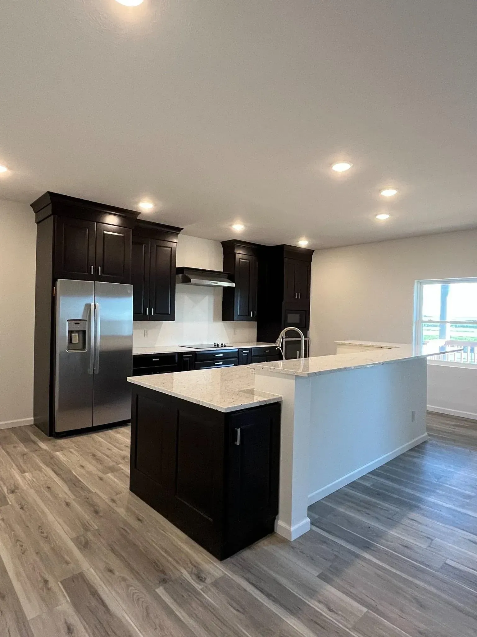 A Kitchen With Black Cabinets — Sioux City, IA — Construction Plus LLC