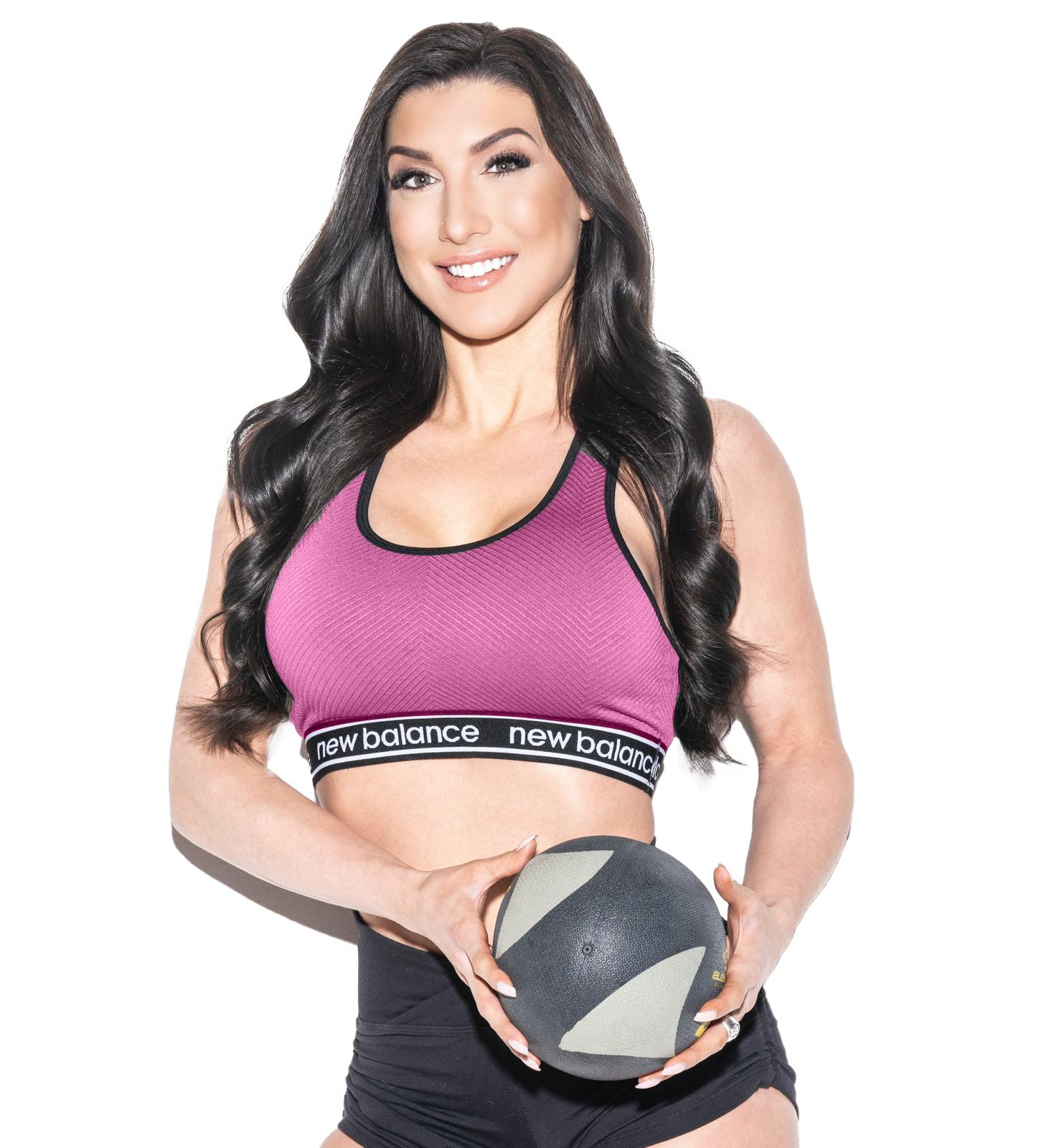 A woman in a pink sports bra and shorts is sitting on the floor.