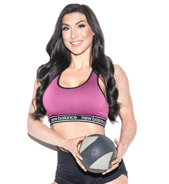 A woman in a pink sports bra and shorts is sitting on the floor.