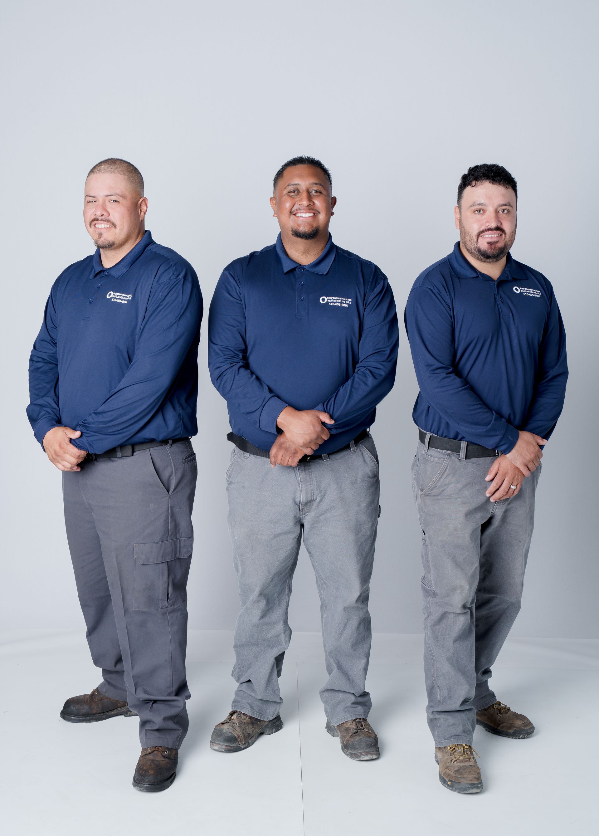 Three men stand confidently side by side.