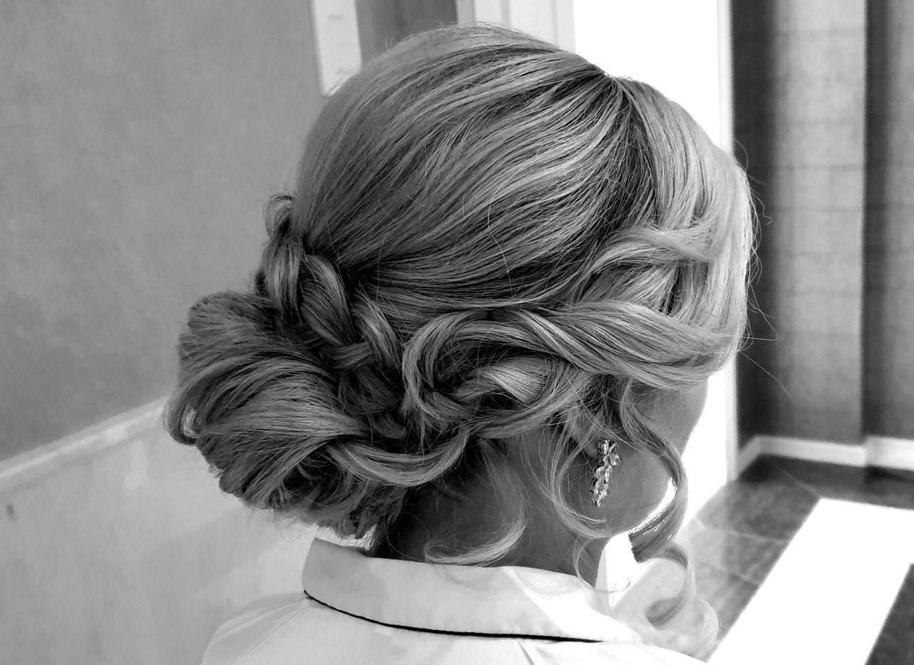 A black and white photo of a woman 's hair in a bun.