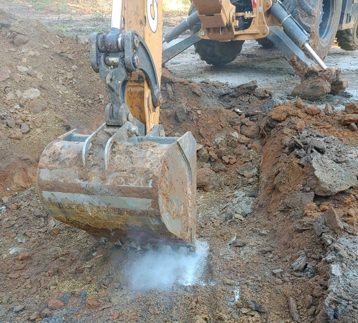 Excavator digging up the ground — Grovetown, GA — Burnley Sanitary Sewer & Drain Service LLC