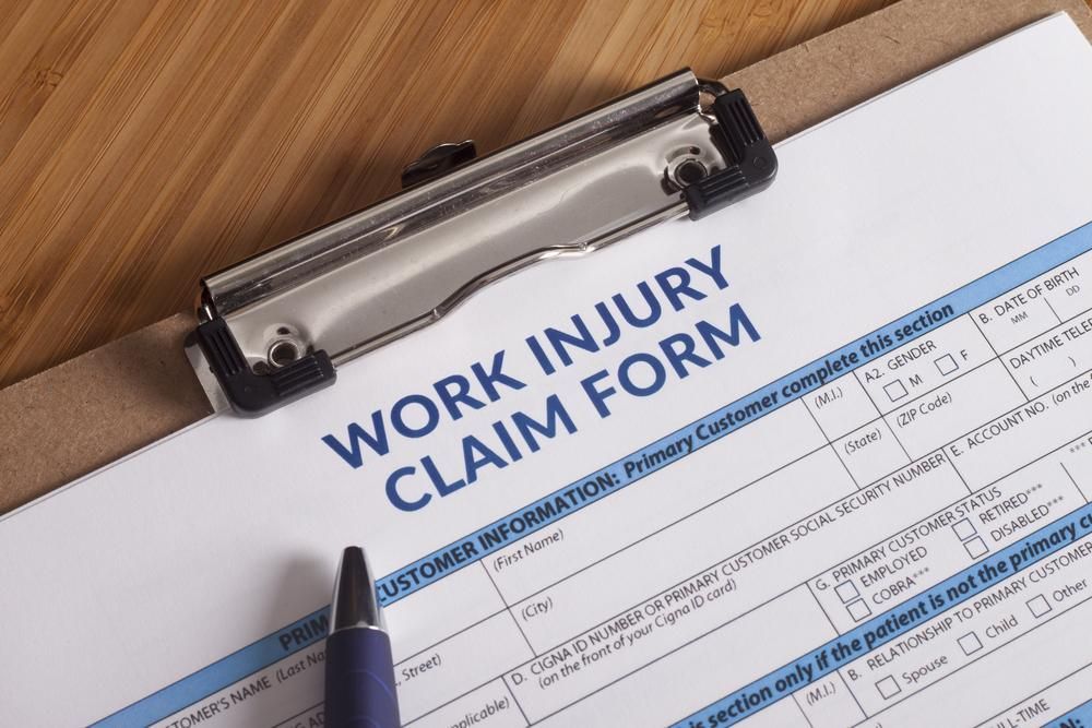 A Clipboard With a Work Injury Claim Form and a Pen on It — Tony Love Lawyers in Ballina, NSW