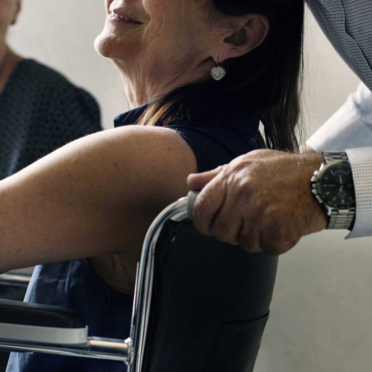 Man Holding A Wheelchair — Tony Love Lawyers in Lismore, NSW