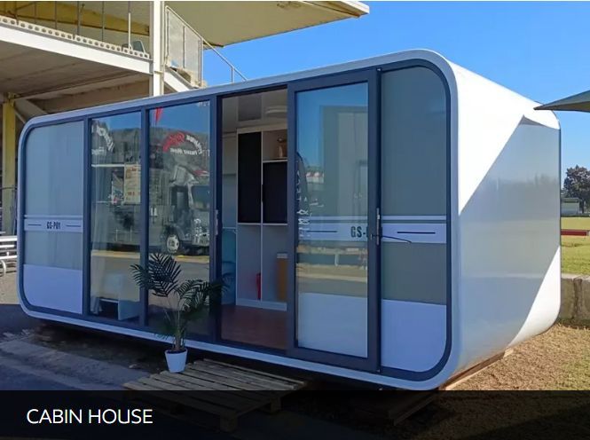 A white cabin house with sliding glass doors