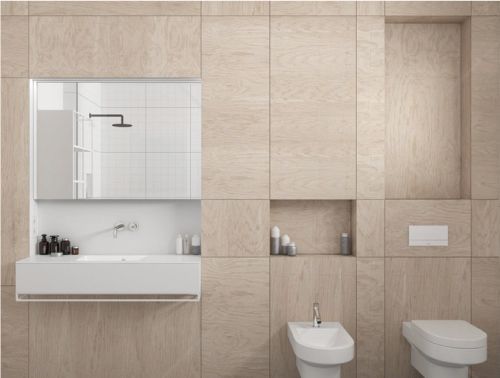 A bathroom with a sink , toilet , bidet and shower.