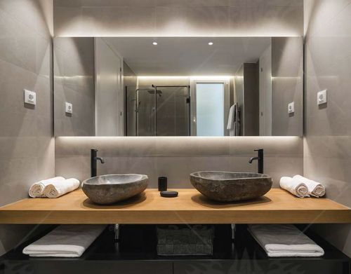 A bathroom with two sinks and a large mirror.