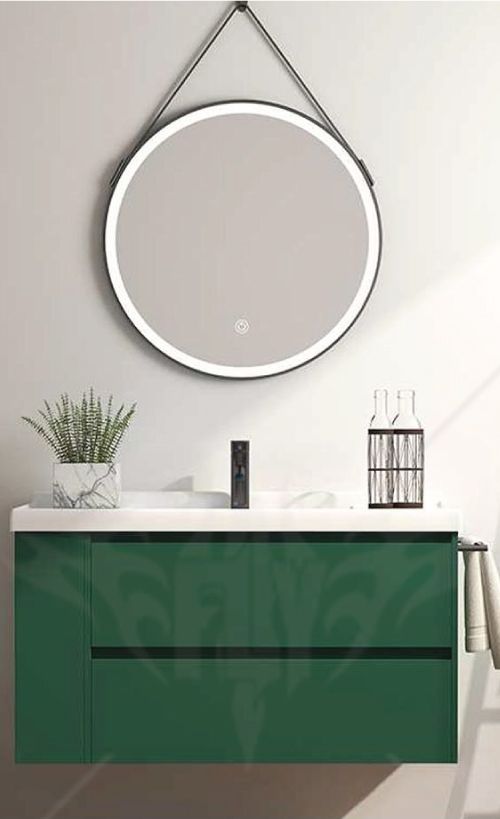 A bathroom with a green vanity , sink and mirror.