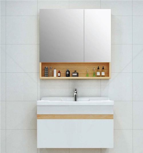 A bathroom with a sink , mirror and shelf.