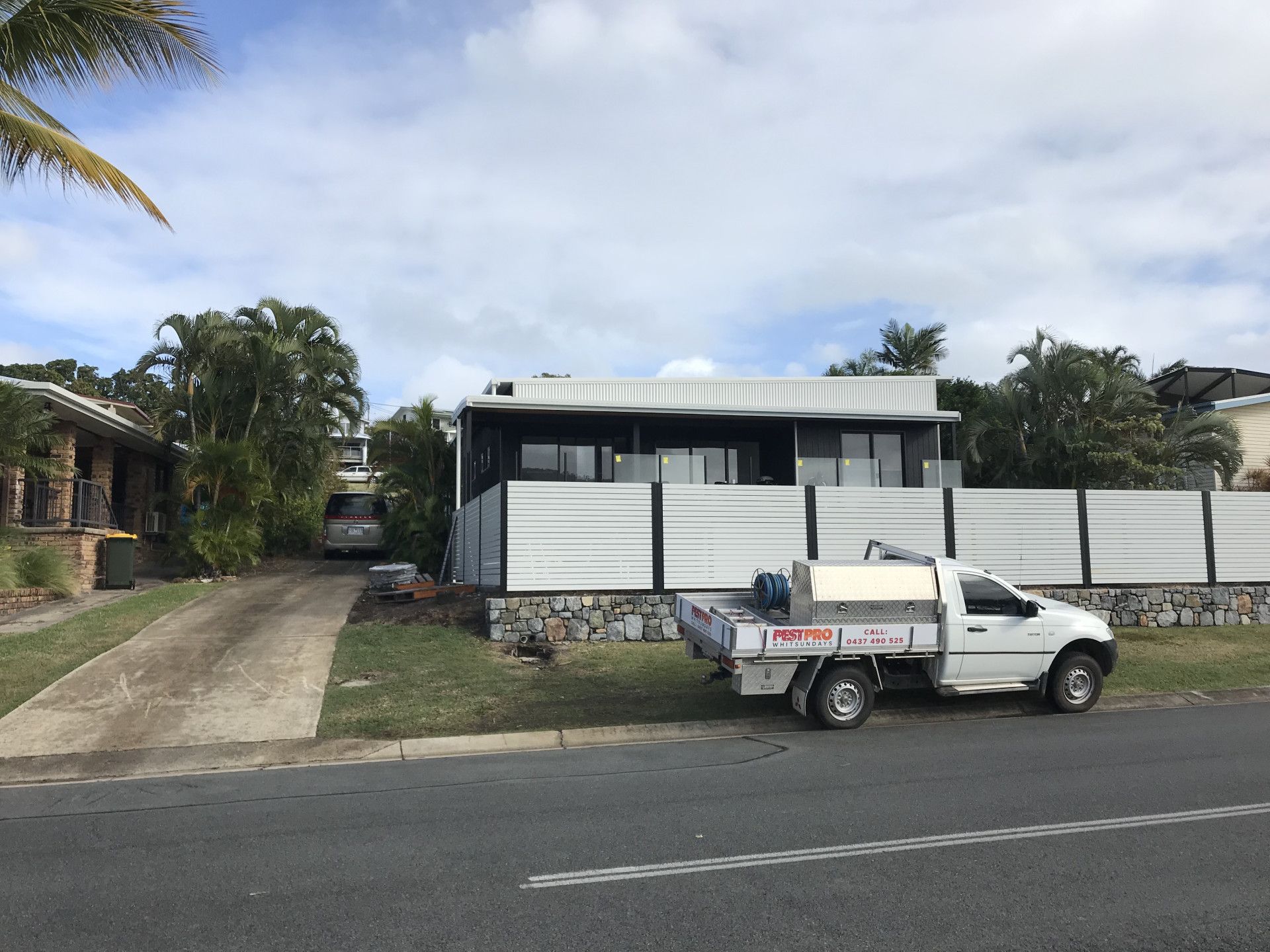 Person Spraying Pesticide on Wood Floor and Wall — Pest Pro Whitsundays in Strathdickie, QLD