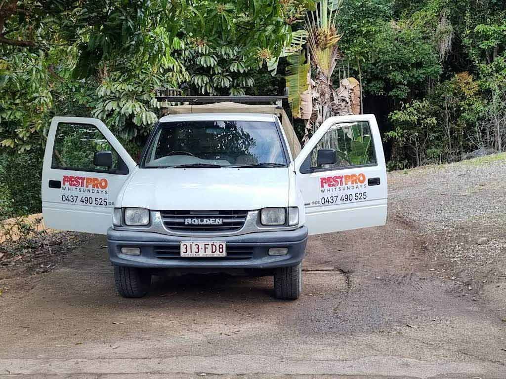 White Truck With Open Doors, Parked on a Driveway, Company Logo on the Side — Pest Pro Whitsundays in Strathdickie, QLD