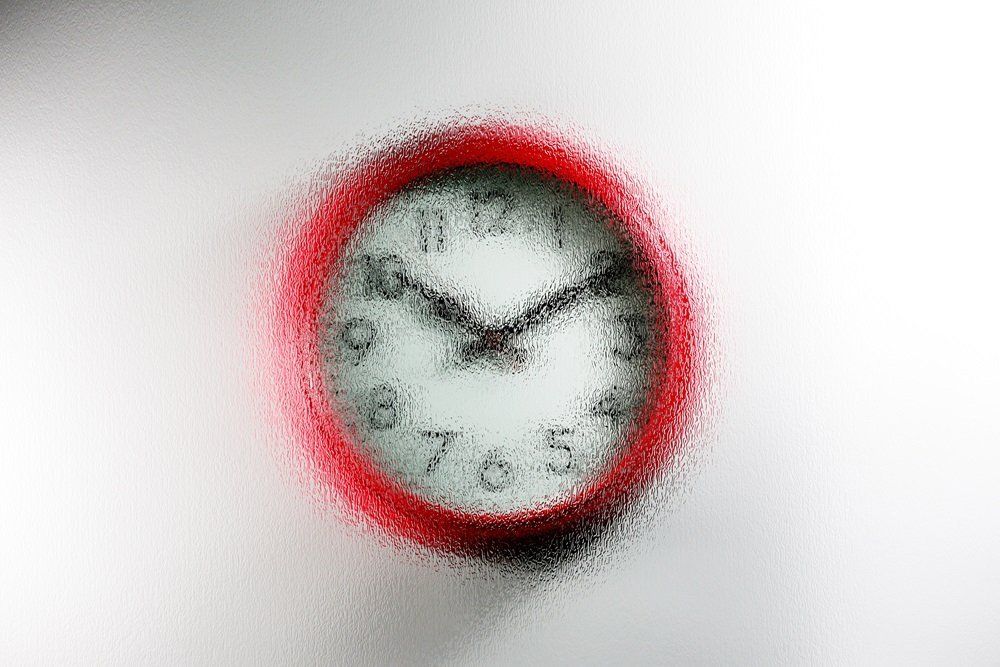 red wall clock with a Contora design