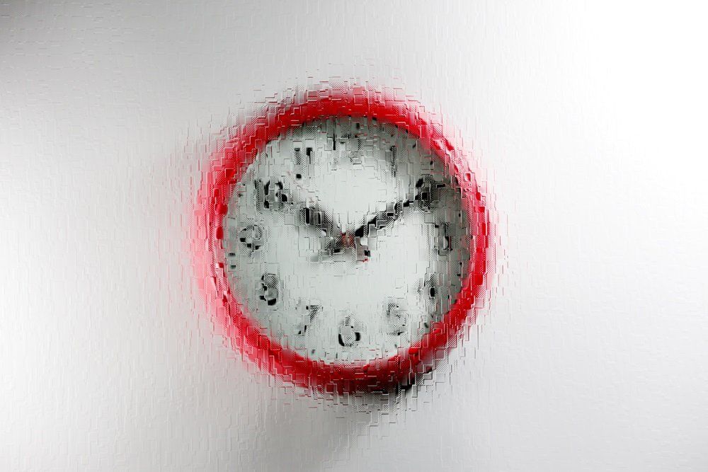 red wall clock with a digital design