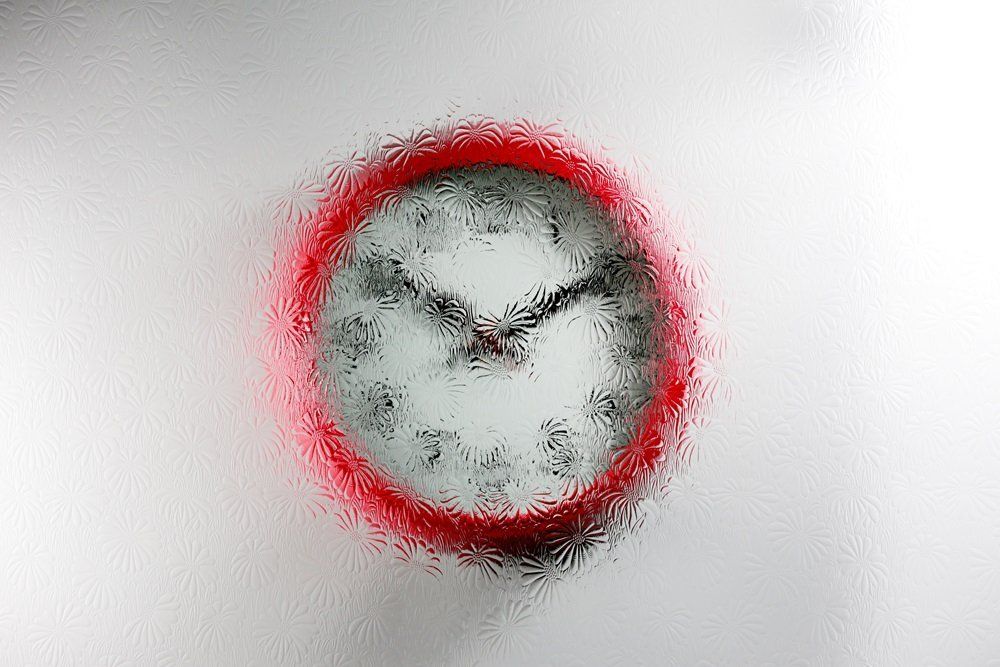 red wall clock with a Mayflower design