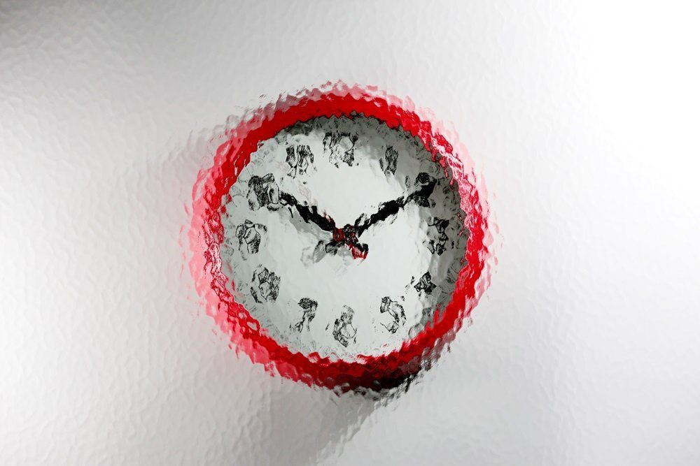 red wall clock with a Minster design