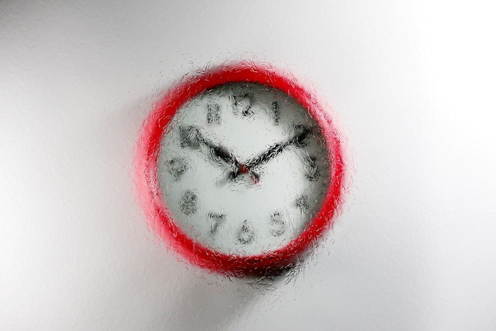 red wall clock with a Oak design