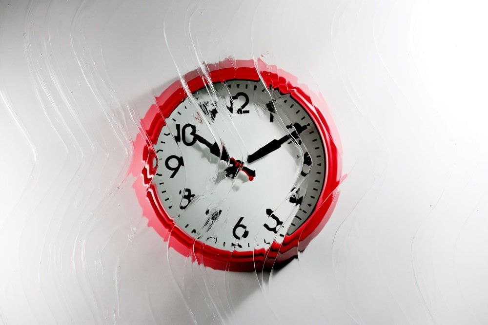 red wall clock with a Warwick design