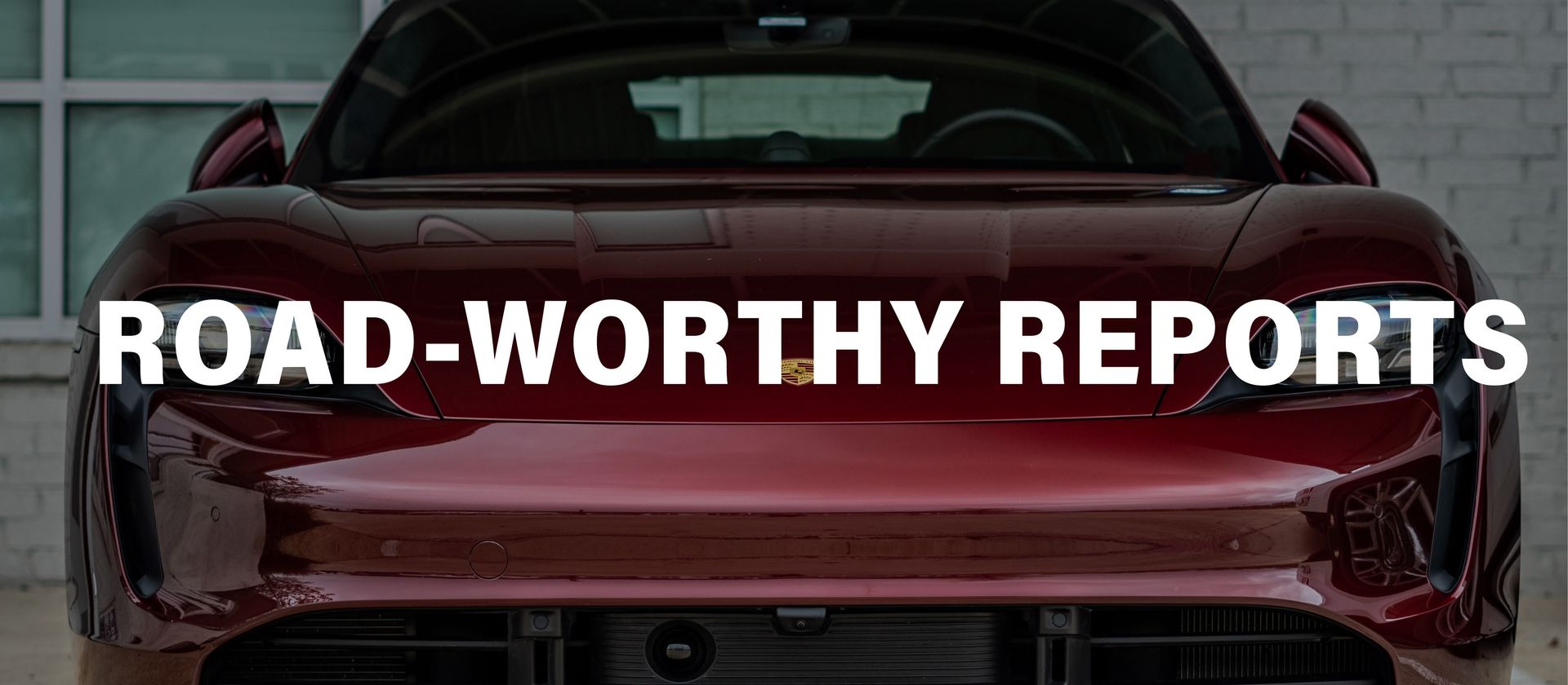 A red sports car is parked in front of a building.