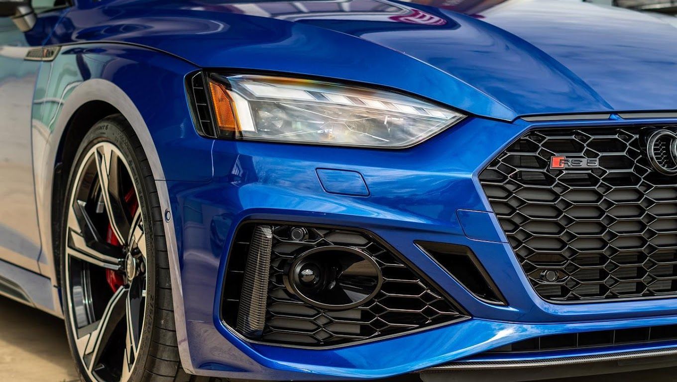 closeup shot of a blue car's headlight