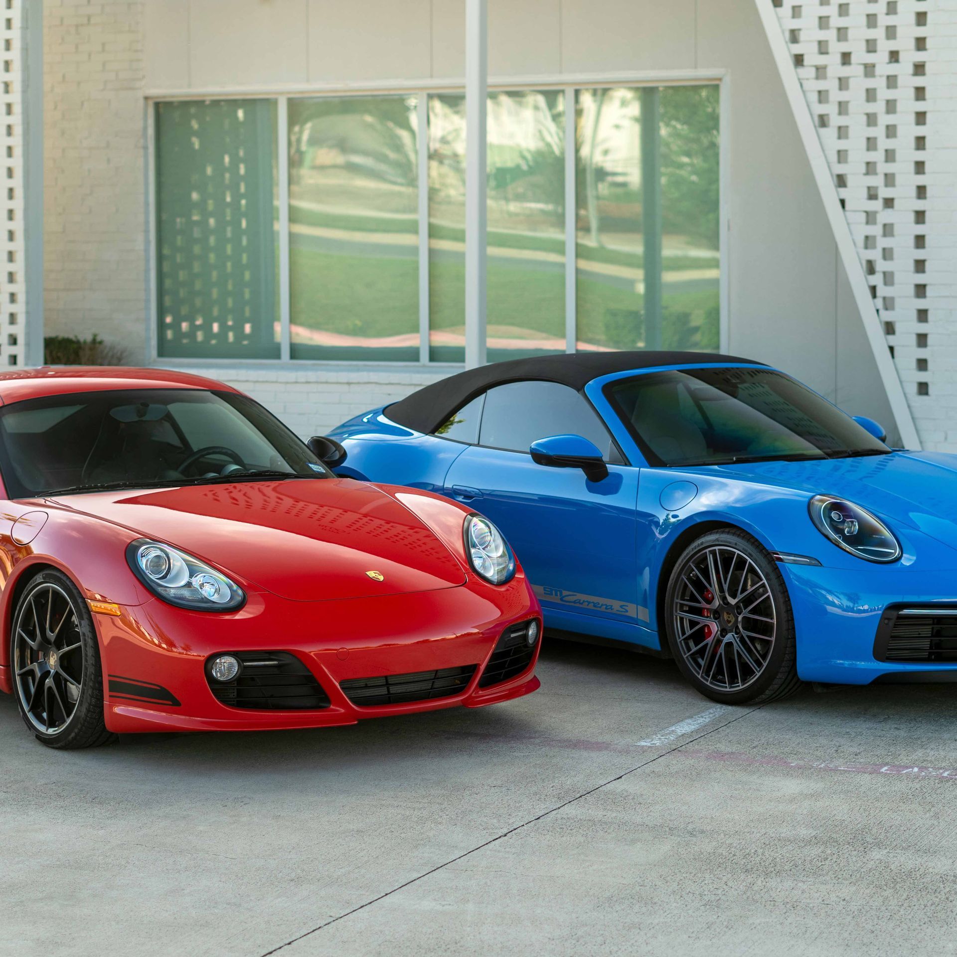 A red car and a blue car are parked next to each other