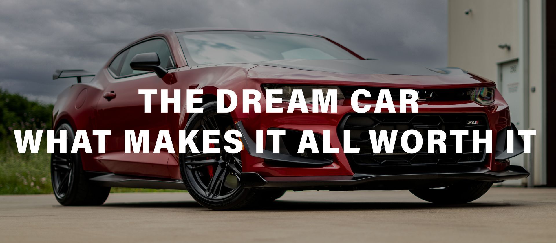 A red car with the words `` the dream car what makes it all worth it '' written on it.
