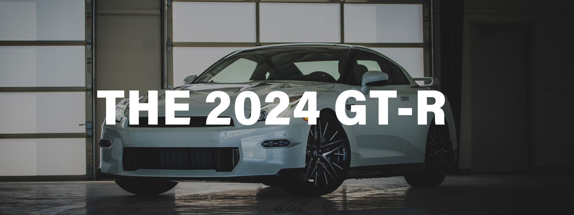 A white car is parked in a garage with the words `` the 2024 gt-r '' written above it.
