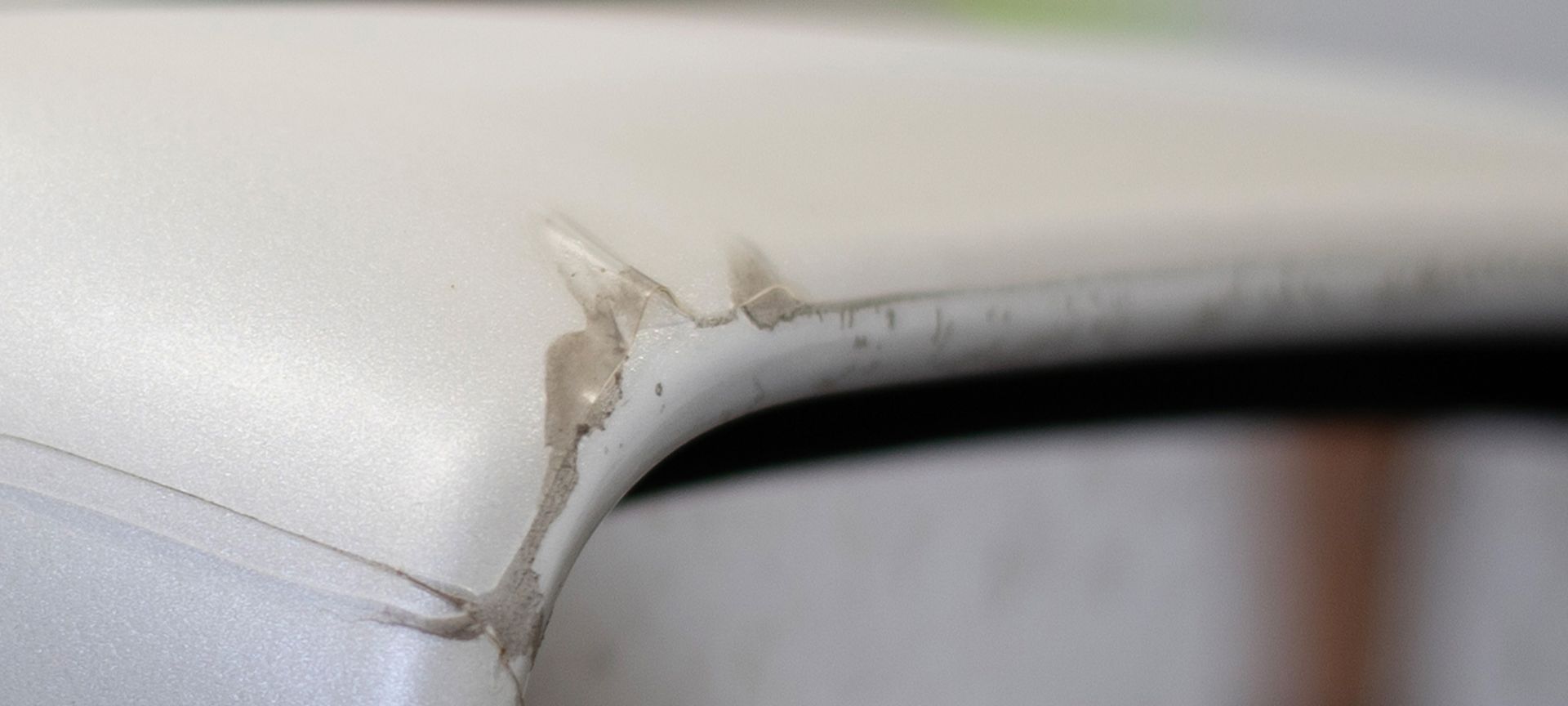 a close up of a piece of white leather with a tear in it .