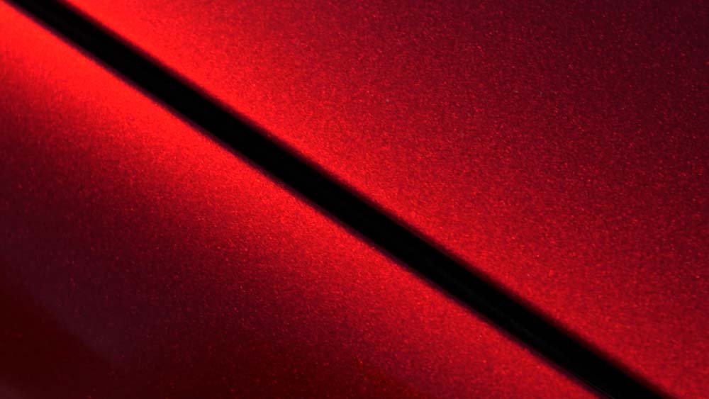 A black line is casting a shadow on a red surface.