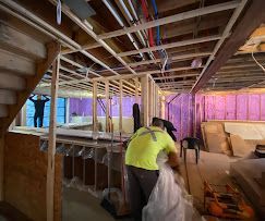 A man is working in a basement under construction.