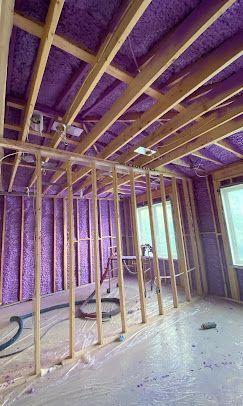 A room with purple insulation on the ceiling and walls.