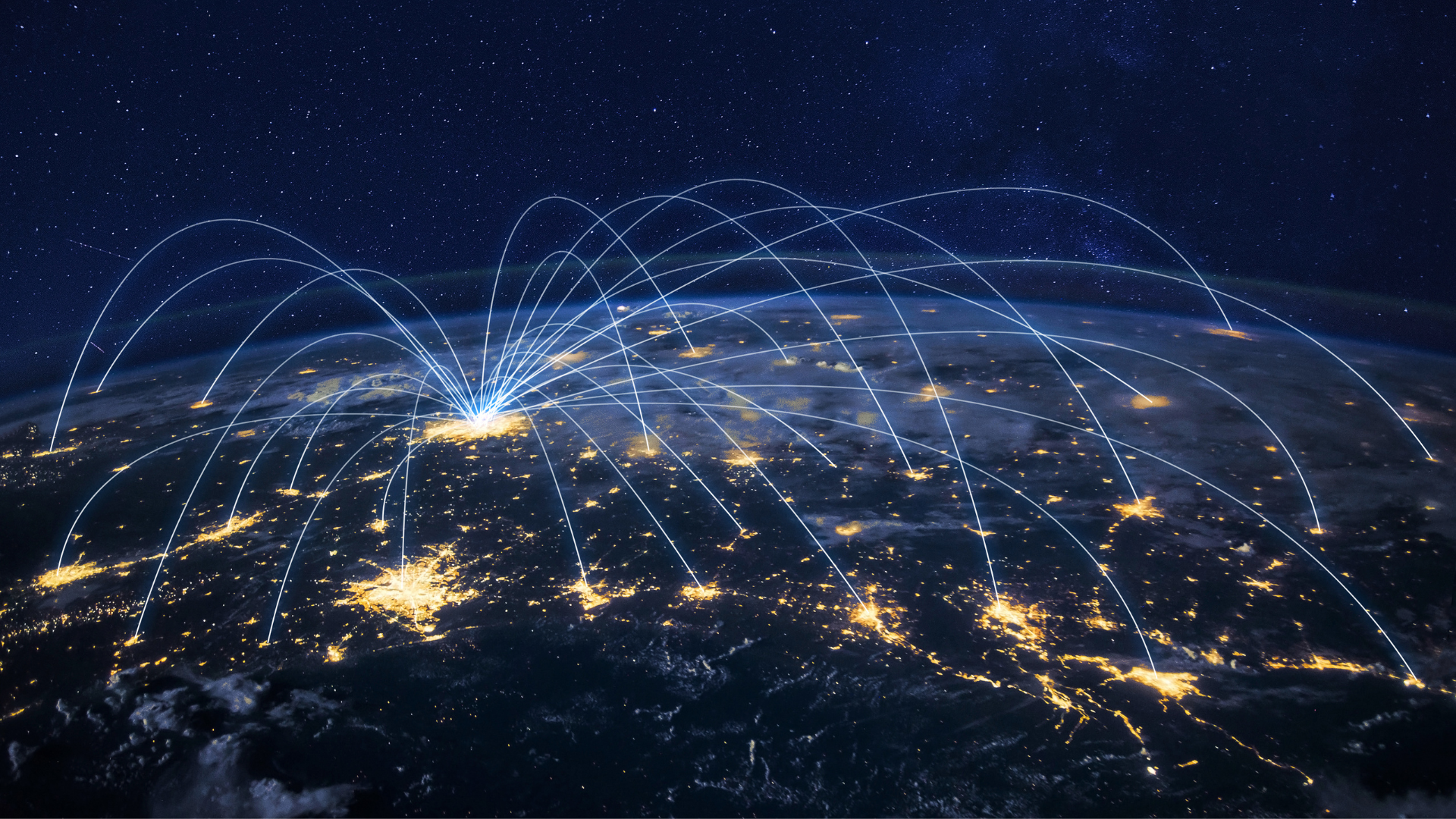 An aerial view of the earth at night with lots of connections.